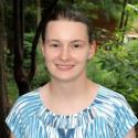 close-up headshot photo of Ashley Earley with background of greenery