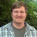 headshot photo of Mason McNair standing in front of greenery